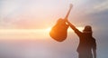 Musician holding acoustic guitar in hand of silhouette on sunset Royalty Free Stock Photo