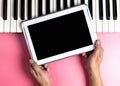 Musician is holding blank tablet screen for music application Royalty Free Stock Photo