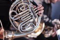 Musician horn player performs his musical part in a symphony orchestra. Unrecognizable, close-up, part of body and hands. Brass Royalty Free Stock Photo