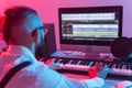 Musician and making music concept - Male sound producer working in recording studio. Royalty Free Stock Photo