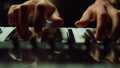 Musician making music in dark hall Man hands pressing keys on piano indoor.