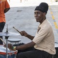 Band member of steel band playing in front of cruiser in Barbados Royalty Free Stock Photo