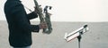 Musician man playing saxophone on the beach