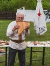 Musician man plying sopilka rebro ethnic woodwind musical instrument. Pan flute music festival Lviv, Ukraine May 14 2022 Royalty Free Stock Photo