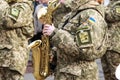 The musician of the military orchestra of the Ukrainian army plays the saxophone