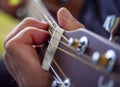 The musician plays a classic wooden acoustic guitar