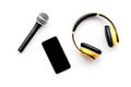Musician office desk with mobile phone, microphone and headphones white background top view copyspace