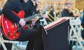 Musician in the orchestra plays the electric guitar