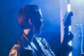 Musician performer holding electric guitar playing heavy metal song in studio preparing rock performance