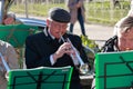 Musician play on cornet in the foreground