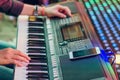 Musician play electronic keyboard synthesizers by using smartphone as guidelines for playing on the concert stage. Selective focus