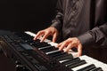 Musician play the keys of the digital piano on black background Royalty Free Stock Photo