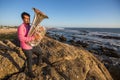 Musician play to Tuba on romantic ocean shore. Love Royalty Free Stock Photo