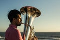 Musician play to Tuba on romantic sea shore. Hobby. Royalty Free Stock Photo