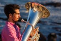 Musician play to Tuba on romantic sea shore. Relax. Royalty Free Stock Photo