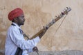 Musician play on traditional music instrument called Kamaycha for tourists on the road in Jaipur, Rajasthan, India Royalty Free Stock Photo