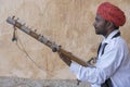 Musician play on traditional music instrument called Kamaycha for tourists on the road in Jaipur, Rajasthan, India Royalty Free Stock Photo