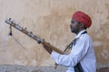 Musician play on traditional music instrument called Kamaycha for tourists on the road in Jaipur, Rajasthan, India Royalty Free Stock Photo