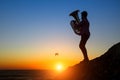 Musician play Tuba on the ocean coast at sunset. Lone. Royalty Free Stock Photo