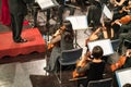 Musician play violin. Female violinist playing the violin stringst with the bands on the concert stage. Closeup.