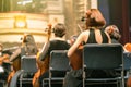 Musician play violin. Female violinist playing the violin stringst on the concert stage. Closeup.