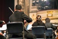 Musician play violin. Violinist playing the violin stringst on the concert stage. Closeup.