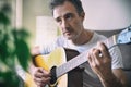 Musician playing acoustic guitar close up in a room Royalty Free Stock Photo