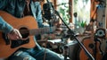 Musician playing an acoustic guitar in a cozy home studio Royalty Free Stock Photo