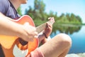 Musician playing acoustic guitar in nature on summer vacation Royalty Free Stock Photo