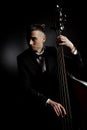 Musician playing on contrabass on dark Royalty Free Stock Photo