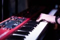 Musician playing on the double keyboard synthesizer piano keys. Musician plays a musical instrument on the concert stage Royalty Free Stock Photo