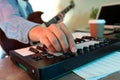 Musician playing on electric guitar and midi keyboard, close up