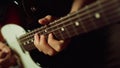 Musician playing electric guitar in studio. Guitarist hand pinching chords Royalty Free Stock Photo