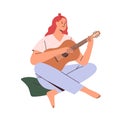 Musician playing guitar. Happy young woman guitarist with musical acoustic instrument. Modern creative relaxed music