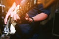 Close up hand young man playing electric guitar at recording studio rehearsal base. rock music band