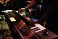 Musician playing on the keyboard synthesizer piano keys. Musician plays a musical instrument on the concert stage Royalty Free Stock Photo