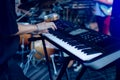 Musician playing on the keyboard synthesizer piano keys. Musician plays a musical instrument on the concert stage Royalty Free Stock Photo