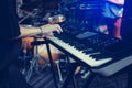 Musician playing on the keyboard synthesizer piano keys. Musician plays a musical instrument on the concert stage Royalty Free Stock Photo