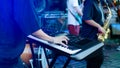 Musician playing on the keyboard synthesizer piano keys. Musician plays a musical instrument on the concert stage Royalty Free Stock Photo