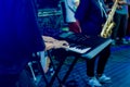 Musician playing on the keyboard synthesizer piano keys. Musician plays a musical instrument on the concert stage Royalty Free Stock Photo