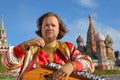 Musician playing an old Russian musical instrument gusli