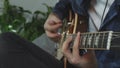 Musician playing rock ballad song on electric guitar practicing for live concept at home