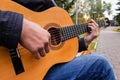 Musician playing a six string guitar in the park Royalty Free Stock Photo