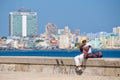 Musician playing the trombone at the famous Malecon wall in Havana