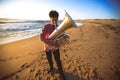 Musician playing the Tuba on the Ocean coast. Hobby. Royalty Free Stock Photo