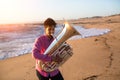 Musician playing the Tuba on the sea coast. Hobby. Royalty Free Stock Photo