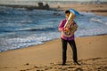 Musician playing the Tuba on the sea coast. Hobby. Royalty Free Stock Photo