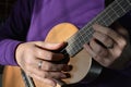 Musician playing ukulele, midsection, hands on strings Royalty Free Stock Photo