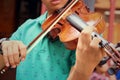 Musician playing violin melodically at the park Royalty Free Stock Photo