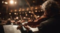 Musician Playing Violin in Symphony Hall with Warm Lighting Royalty Free Stock Photo